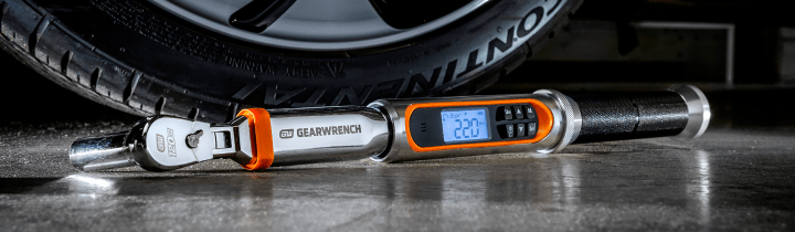 GEARWRENCH electronic torque wrench laying in front of a car tire