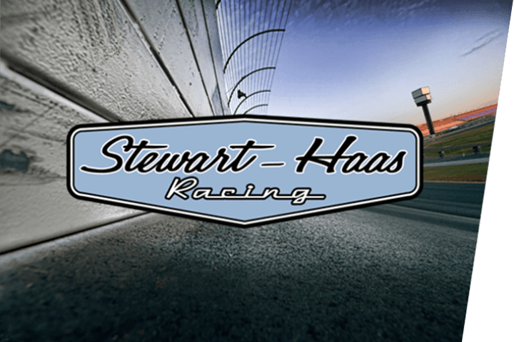 Stewart Haas Racing logo with NASCAR racetrack background