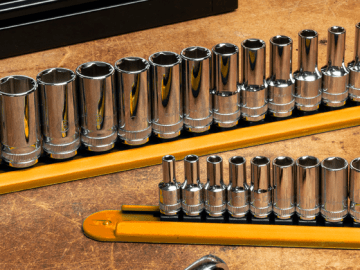 GEARWRENCH chrome sockets on orange socket rails on top of work table