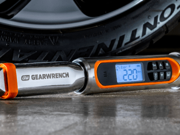 GEARWRENCH electronic torque wrench laying in front of a car tire